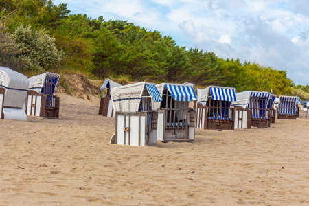 Lonely beach wooden wicker chairs on beach Baltic Sea, Germanyの写真素材