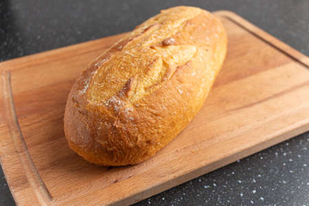 white bread on brown wood cutting boardの写真素材
