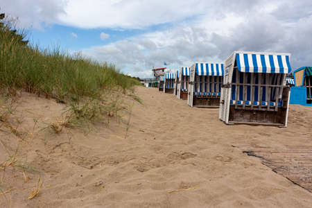 Lonely beach wooden wicker chairs on beach Baltic Sea, Germany cloud summerの写真素材