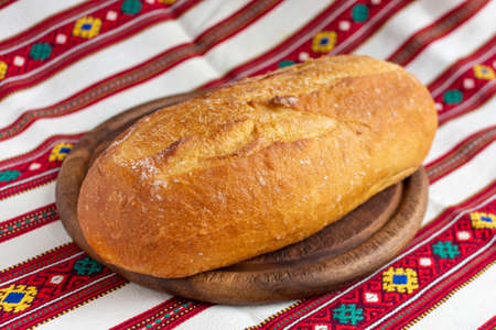 white bread on brown wood cutting boardの写真素材