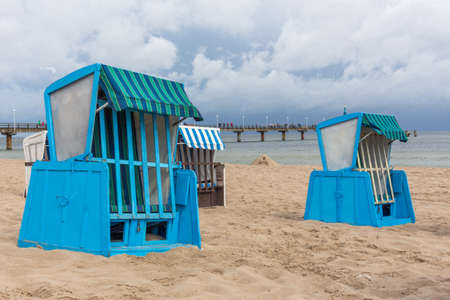 Lonely beach wooden wicker chairs on beach Baltic Sea, Germany cloud summerの写真素材