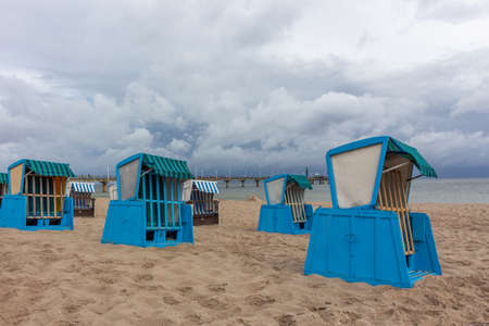 Lonely beach wooden wicker chairs on beach Baltic Sea, Germanyの写真素材