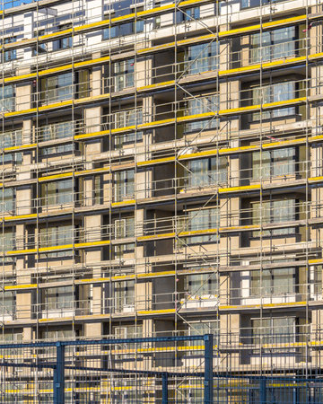 Modern building is under construction, metal scaffolding close upの写真素材