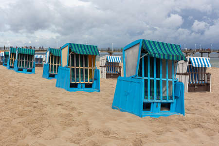 Lonely beach wooden wicker chairs on beach Baltic Sea, Germanyの写真素材