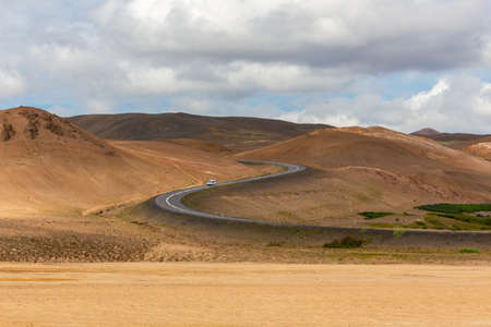 Hverir hill S curve road images Iceland cloud sky car on the road horizontalの写真素材