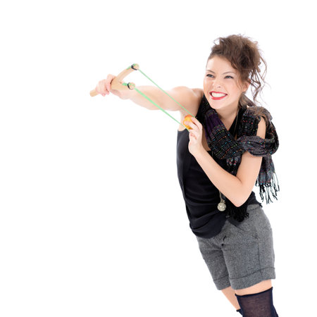 Young woman with slingshot isolated on whiteの写真素材
