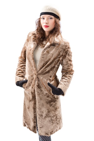 Beautiful young woman in a coat  on white backgroundの写真素材