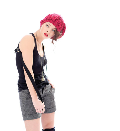 Serious young woman in  pink hat white backgroundの写真素材