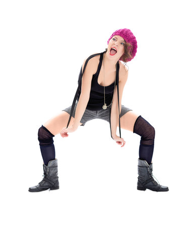 Screaming young woman in military boots and pink hat on white backgroundの写真素材