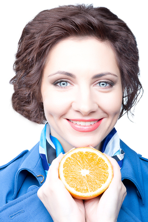 Beauty  woman with orange half on whiteの写真素材