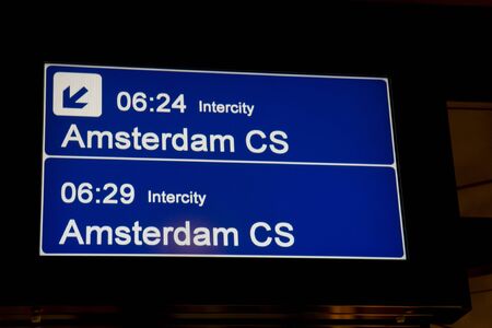 Sign for the train to Amsterdam, the Netherlands, from the platform at Schiphol Airportの写真素材