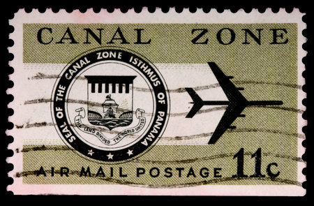 CANAL ZONE, PANAMA - CIRCA 1973: An 11-cent air mail stamp printed in the Canal Zone, Isthmus of Panama, shows the Canal Zone seal and a jet, circa 1973のeditorial素材