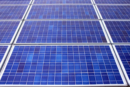 Panels of solar collection cells fill the frame horizontalの写真素材