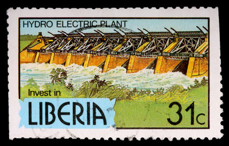 LIBERIA - CIRCA 1981: A 31-cent stamp printed in Liberia shows a hydro electric plant to encourage investment, circa 1981のeditorial素材
