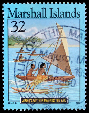 REPUBLIC OF THE MARSHALL ISLANDS - CIRCA 1995: A 32-cent stamp printed in the Republic of the Marshall Islands shows islanders in canoes to illustrate the story of Jebro's mother invents the sail, circa 1995のeditorial素材