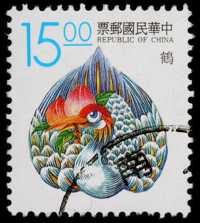 REPUBLIC OF CHINA (TAIWAN) - CIRCA 1990: A 15-dollar stamp printed in the Republic of China (ROC, Taiwan) shows a legendary phoenix bird with a lotus flower in its beak, circa 1990のeditorial素材