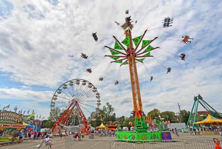 INDIANAPOLIS, INDIANA - AUGUST 12: The ferris wheel and other rides on the Midway at the Indiana State Fair on August 12, 2012. This very popular fair hosts more than 850,000 people every August.のeditorial素材