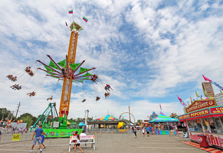 INDIANAPOLIS, INDIANA - AUGUST 12: The Vertigo and other rides on the Midway at the Indiana State Fair on August 12, 2012. This very popular fair hosts more than 850,000 people every August.のeditorial素材