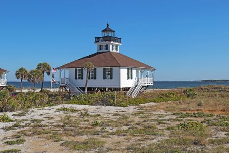 The Port Boca Grande Lighthouse on Gasparilla Island, Florida against a bright blue skyの写真素材