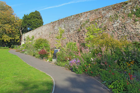 Flowers along part of the city wall in Northernhay Gardens, Devon. These gardens on the northern side of Rougemont Castle are the oldest public open space in England.のeditorial素材