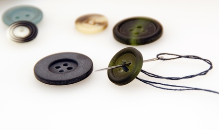 Sew a button with a needle and threadの写真素材