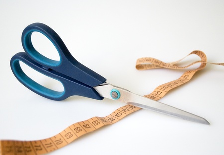 Scissors and measuring tape stretchedの写真素材