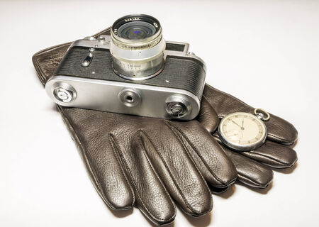 Film camera, pocket watch and leather glovesの写真素材