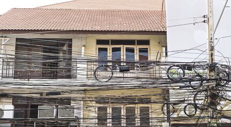 Electric wires in city in Thailandの写真素材