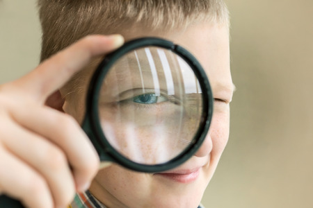 Brainy boy with magnifying glassの写真素材
