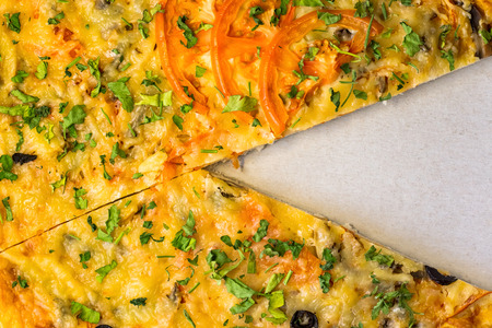 Pizza with a cut pieceの写真素材