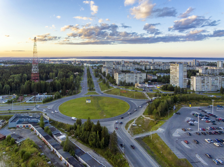 Aerial view on the road ring in the city at summer sunset
