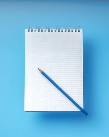 Notebook with a blue pencilの写真素材