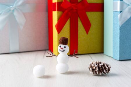 Christmas snowman and gift boxes on wooden backgroundの写真素材