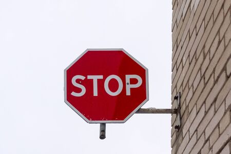 Stop road sign mounted on the wallの写真素材