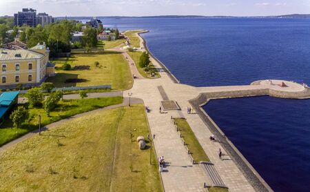 Tourists and citizens on city lake promenade in summer, aerial viewの写真素材