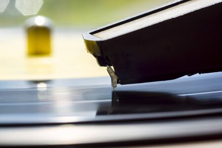 Needle of old gramophone on spinning retro vinyl music record