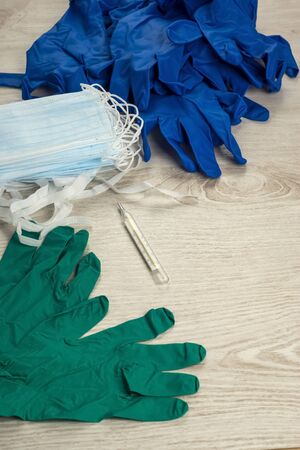 Packs of medical masks, protective gloves and mercury thermometer, vertical