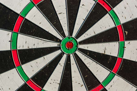 Background of old dart board with many holes