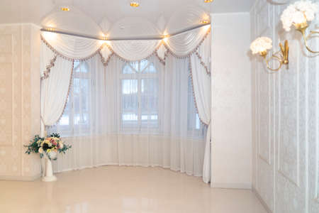 A hall with old rounded windows and elegant interior in soft colorsのeditorial素材