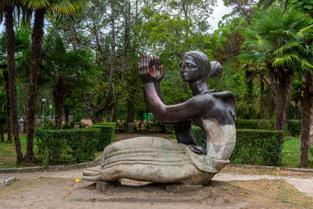 Sculpture of a woman in old unkempt palm park of resort townのeditorial素材