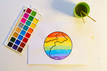 Watercolor palette and paper with Drawn Earth painted with watercolorsの写真素材