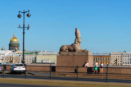 Tourists take photos at statue of antique Egyptian sphinx in St. Petersburg cityのeditorial素材