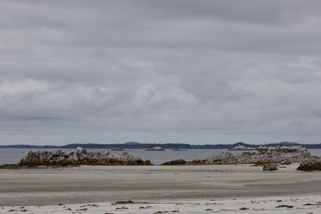 Isolated beach on an overcast day with rocks in the foregroundの写真素材