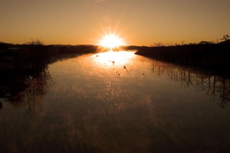 December sunrise over a river in the Texas hill countyの写真素材