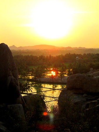 Sunset over the rice paddies of Hampi in Indiaの写真素材