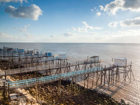 Fishing huts near Royan, Charente Maritime, France in evening sunlight over Gironde estuary on Atlantic coastの写真素材