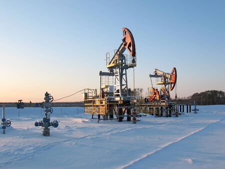 Oil pump jack in work. Oil industry in West Siberia. Siberian frost in sunny day.の写真素材