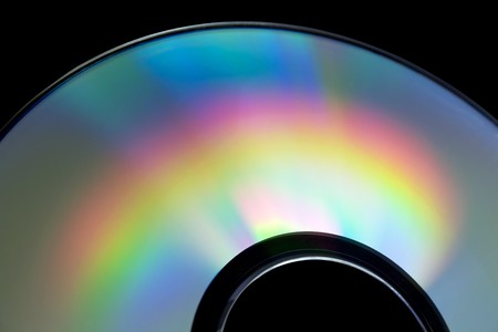 Rainbow on a compact disk . Isolated on black の写真素材