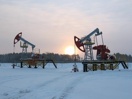 Oil pump jack in work. Oil industry in West Siberia. Siberian frost in sunny day.の写真素材