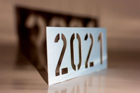 2021 as year number, graphic element year made of cardboard with black shadow as paper cut, photo at an angle with blurの写真素材